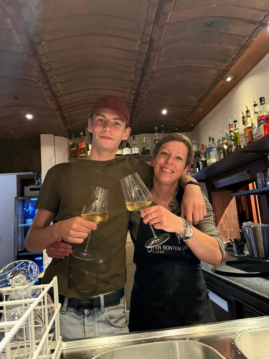 Het team klinkt met witte wijn aan de bar